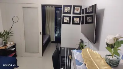 a living room with a couch and a tv at Moana SEA RESIDENCE condotel in Manila