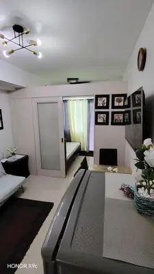 a living room with a tv and a couch at Moana SEA RESIDENCE condotel in Manila