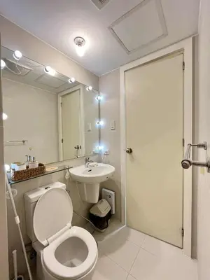a bathroom with a toilet and a sink at Panglao Staycation in Manila