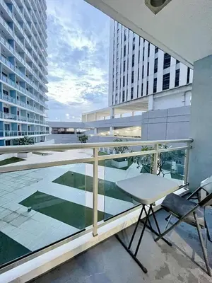 a balcony with a table and chairs on a building at Panglao Staycation in Manila