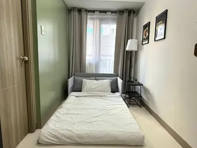 a small bed in a room with a window at S Residences MOA by darpm in Manila