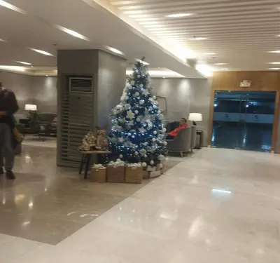 a christmas tree in the middle of a lobby at S Residences MOA by darpm in Manila