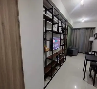 a living room with a television and a table at S Residences MOA by darpm in Manila