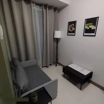 a living room with a couch and a table at S Residences MOA by darpm in Manila