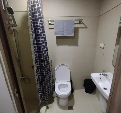 a bathroom with a toilet and a shower and a sink at S Residences MOA by darpm in Manila