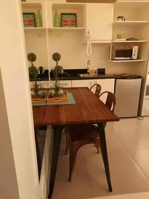 a kitchen with a wooden table with plants on it at COZY COVE IN venice MCKINLEY HILL in Manila