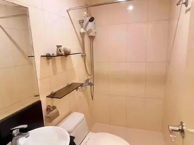 a small bathroom with a toilet and a sink at COZY COVE IN venice MCKINLEY HILL in Manila