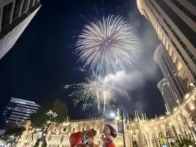 a firework display in front of a building with buildings at COZY COVE IN venice MCKINLEY HILL in Manila
