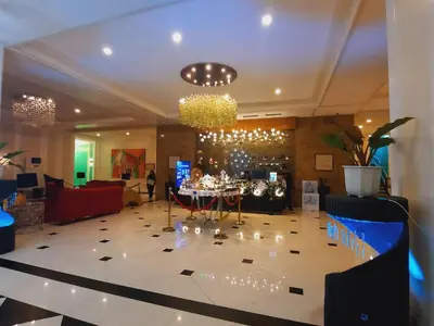 a lobby with a table with wine glasses on it at COZY COVE IN venice MCKINLEY HILL in Manila