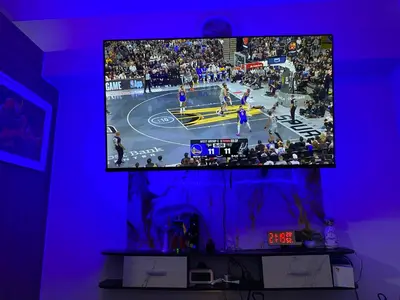 a tv screen with a basketball game on a court at Shore 2 in Manila