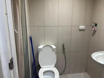 a bathroom with a toilet and a sink at Ate Aby's Place 338 in Manila