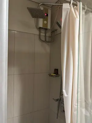 a bathroom with a shower with a shower curtain at Ate Aby's Place 338 in Manila