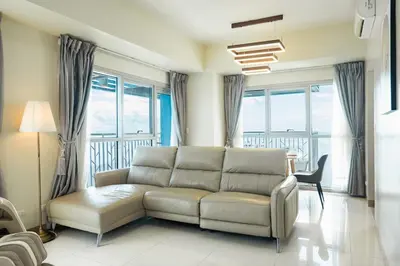 a living room with a couch and some windows at Elegant 3 Bedroom unit with Ocean View near Okada in Manila