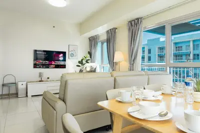 a living room with a table and a couch at Elegant 3 Bedroom unit with Ocean View near Okada in Manila