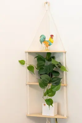 a white shelf with a chicken and a plant at Peaceful & Calm 1BR Studio l Near MOA, SMX & NAIA in Manila