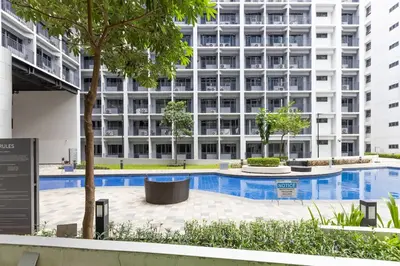 an image of an apartment building with a swimming pool at Peaceful & Calm 1BR Studio l Near MOA, SMX & NAIA in Manila