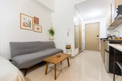 a small room with a bed and a table in it at Peaceful & Calm 1BR Studio l Near MOA, SMX & NAIA in Manila
