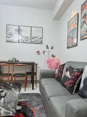 a living room with a couch and a table at Queen Bed with Coffee Bar and Fast Wi-Fi at S Residences in Manila