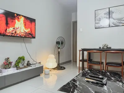 a living room with a fire on the wall at Queen Bed with Coffee Bar and Fast Wi-Fi at S Residences in Manila
