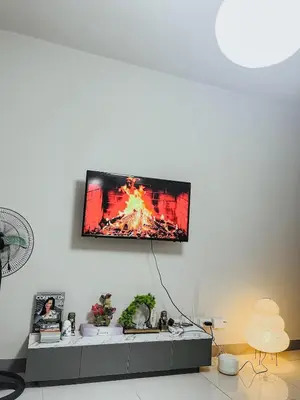 a tv hanging on a wall in a living room at Queen Bed with Coffee Bar and Fast Wi-Fi at S Residences in Manila