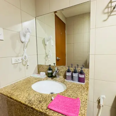 a bathroom with a sink and a mirror at Luxe 1BR BGC with Balcony in Manila