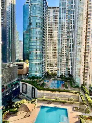 a view of a city with a pool in front of tall buildings at Luxe 1BR BGC with Balcony in Manila