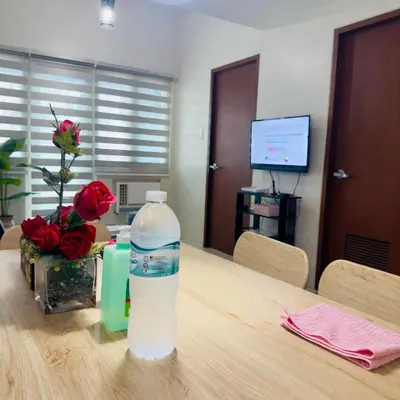 a bottle of water sitting on top of a wooden table at Luxe 1BR BGC with Balcony in Manila