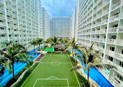 an image of a tennis court in the middle of a building at Moments Staycations in Manila