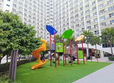 a playground in front of a large building at Moments Staycations in Manila