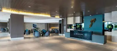 a lobby with chairs and a large screen in a building at Moments Staycations in Manila