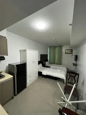 a bedroom with a bed and a kitchen with at The Serenity Tower 2011 in Manila
