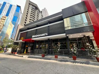 a store with plants in front of a building at Mandala Stays - The Family Suite in Manila