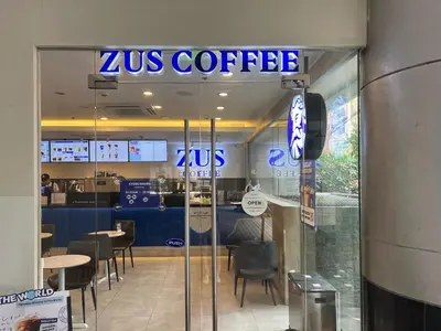 a zus coffee shop with a sign on the door at Mandala Stays - The Family Suite in Manila