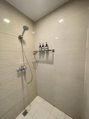 a bathroom with a shower with three bottles on a shelf at Venice Luxe Suite, 1 Bedroom Maximum, 4 adults plus kids in Manila