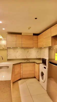 a kitchen with a washer and a washing machine at Venice Luxe Suite, 1 Bedroom Maximum, 4 adults plus kids in Manila