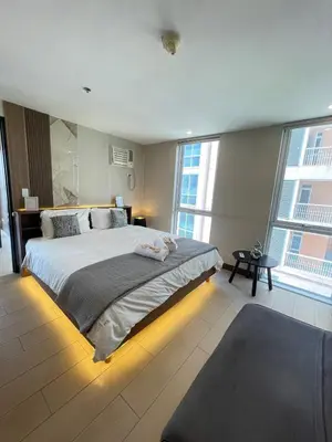 a large bedroom with a large bed with lights on it at Venice Luxe Suite, 1 Bedroom Maximum, 4 adults plus kids in Manila