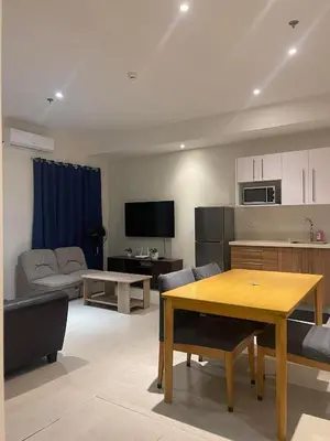 a living room with a table and a kitchen at Condotels by Tribecca Private in Manila