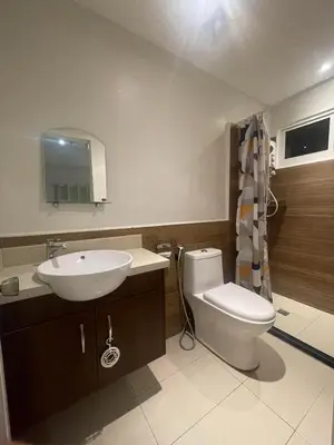 a bathroom with a white toilet and a sink at Condotels by Tribecca Private in Manila