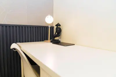 a table with a lamp on top of it at Casa Celestine Staycation in Manila