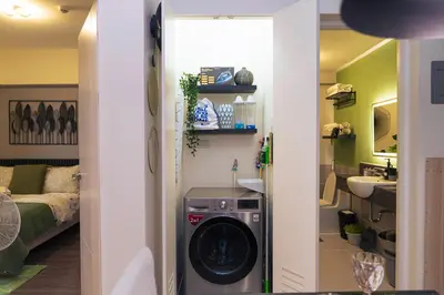 a washer and dryer in a small room at Casa Celestine Staycation in Manila
