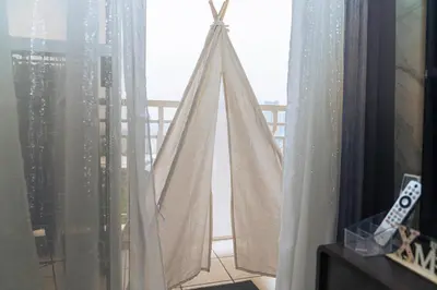 a room with a window with white curtains at Casa Celestine Staycation in Manila
