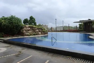 a large swimming pool in a parking lot at Casa Celestine Staycation in Manila