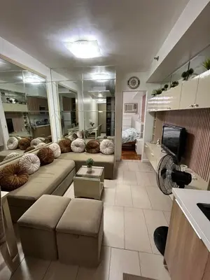 a living room with a couch and a tv at Antel Spa Residences 2509 in Manila