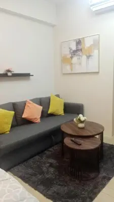 a living room with a couch and a table at Cluster 4 10f in Manila