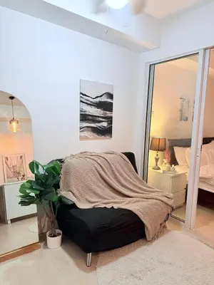 a bedroom with a bed and a large mirror at Vacation Home MOLUAN in Manila