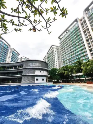 a swimming pool in the middle of a city with tall buildings at Vacation Home MOLUAN in Manila