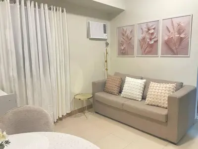 a living room with a couch and a table at Manhattan Plaza Suite 1BR with City View, Netflix and Pool Access in Manila