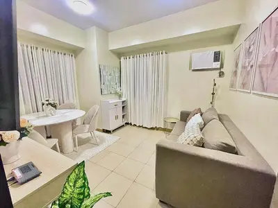 a living room with a couch and a table at Manhattan Plaza Suite 1BR with City View, Netflix and Pool Access in Manila