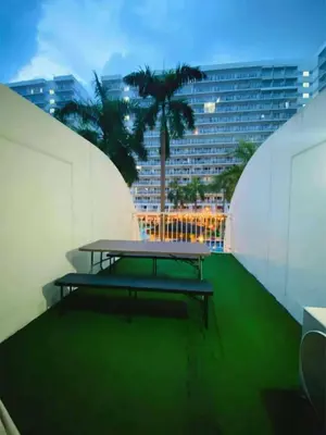 a picnic table sitting on top of a building at 232 1br big balcony 2 queen size 1-sofa bed 1single extra mattress in Manila