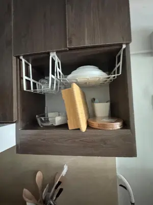 a cupboard with some dishes and plates in it at Overnight sleeps in Manila